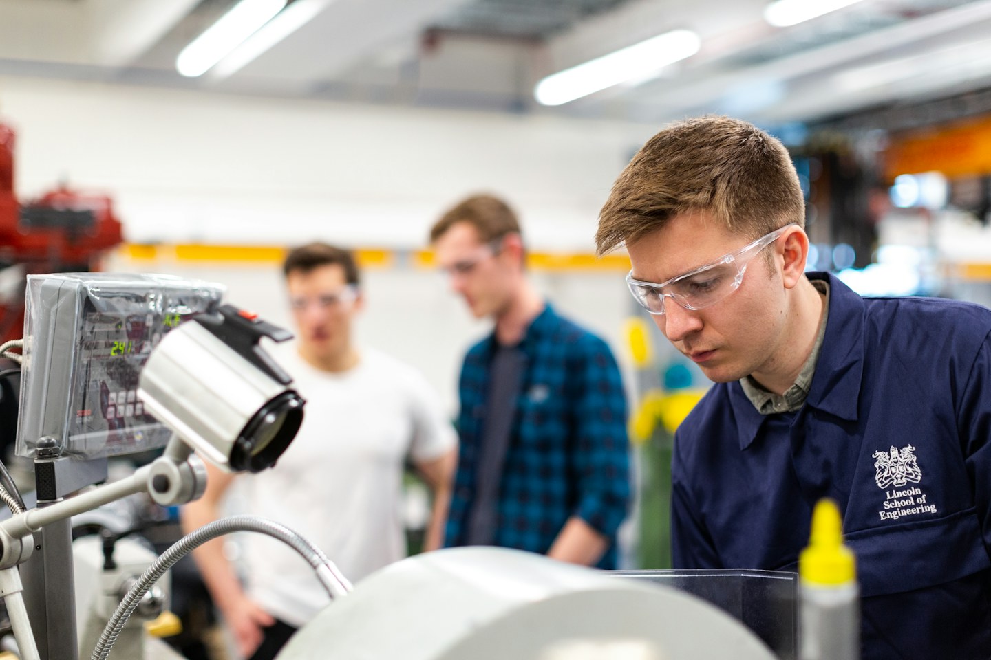 Engineering team working with equipment in a manufacturing workshop